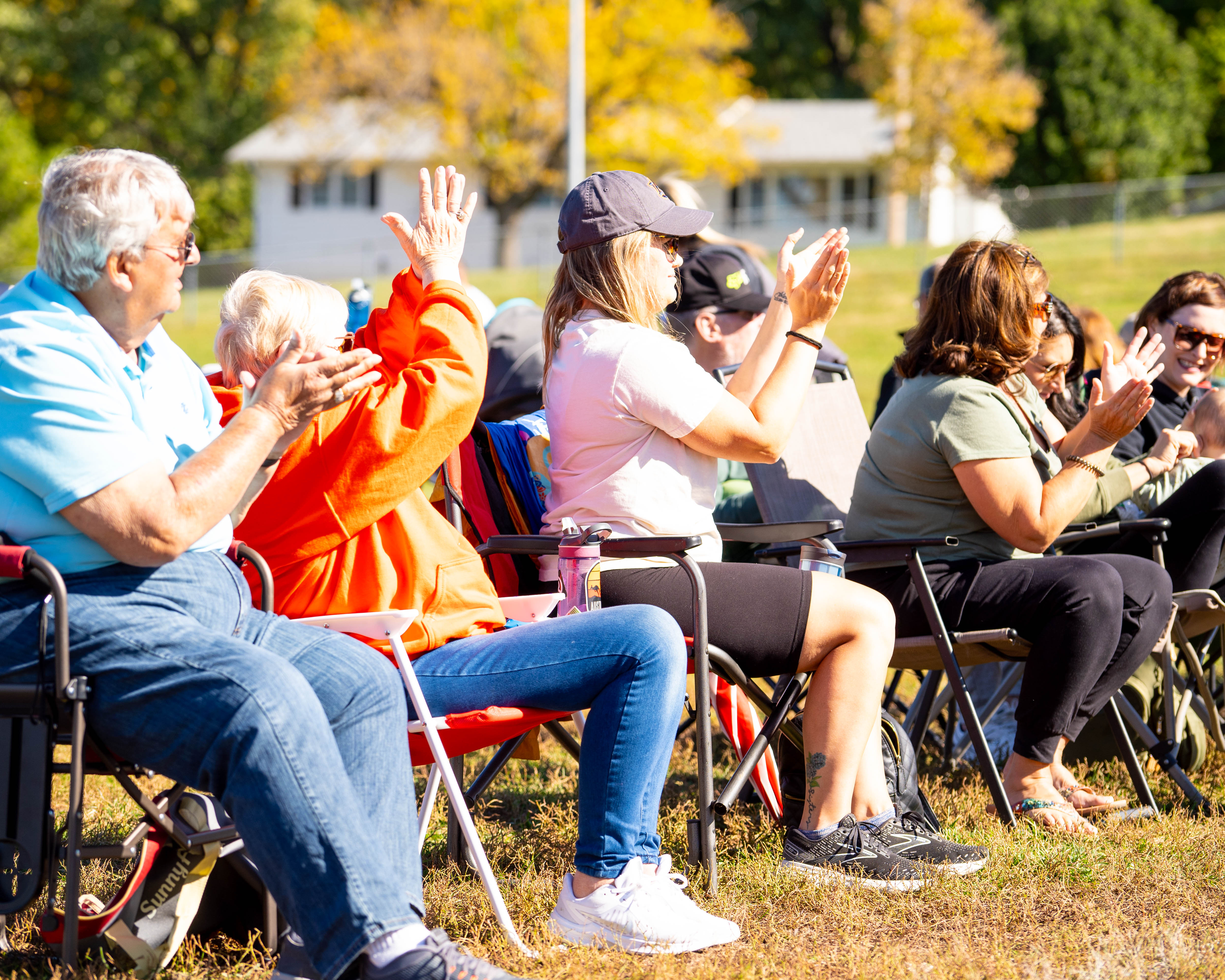Parents and families cheering from their sideline chairs